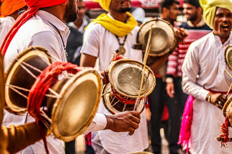A dhol player performing at a wedding